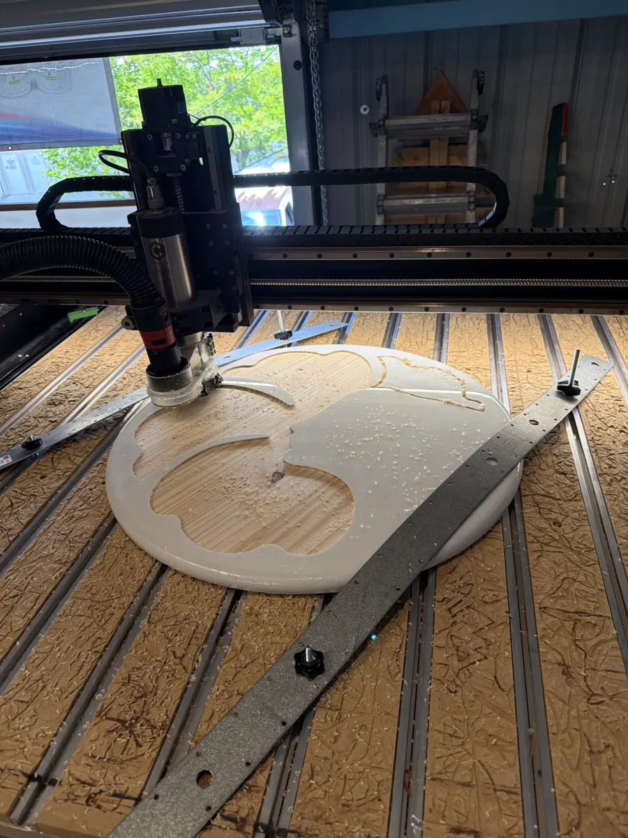 CNC router carving a round sign