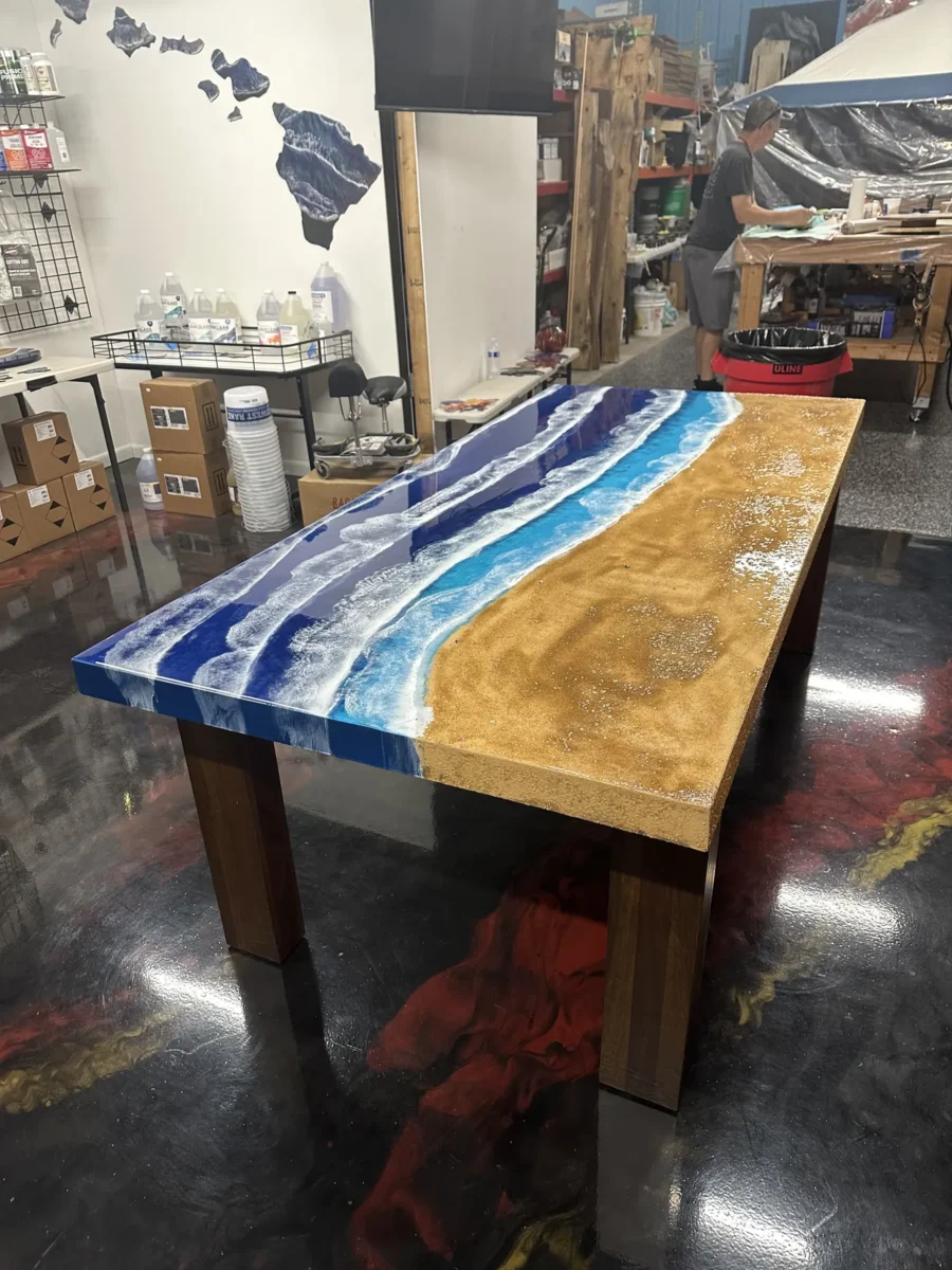 Dining table with an ocean wave resin edge